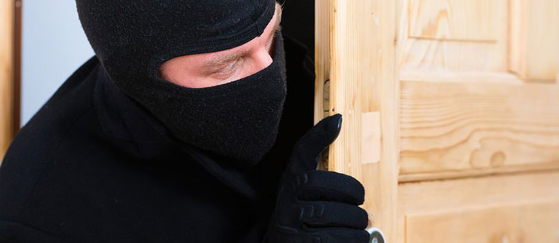 Burglar sneaking into a room.