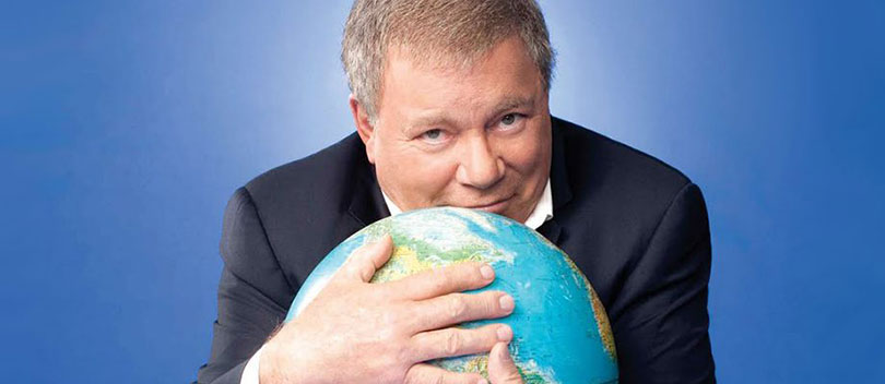 William Shatner hugging a globe.