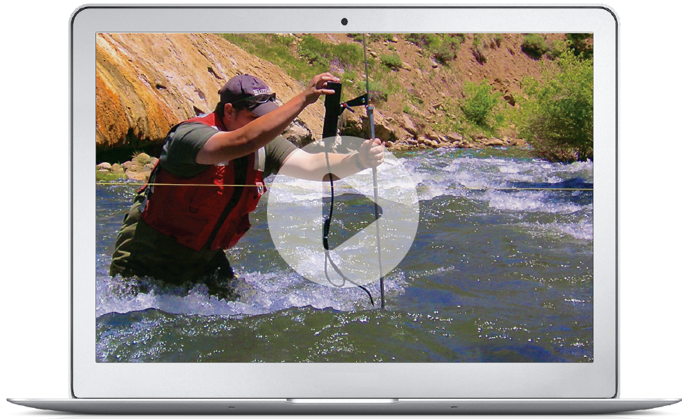 Laptop Displaying Play Button Over Scientist Taking River Measurements.